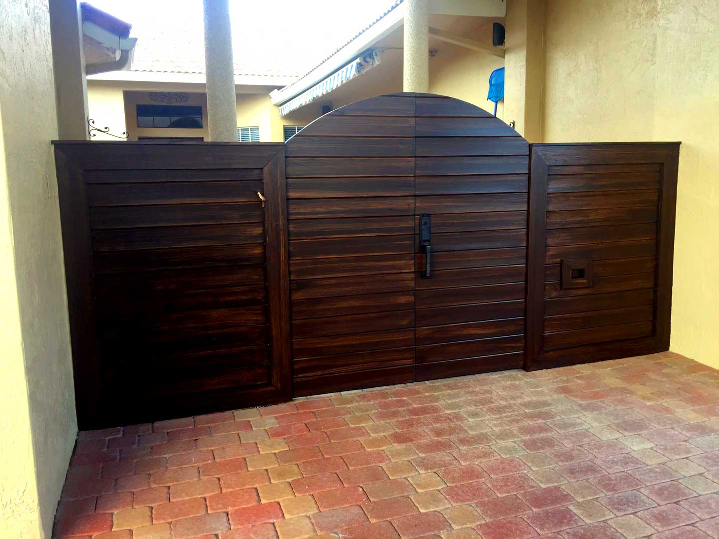 Faux dark walnut finish on horizontal slat gate