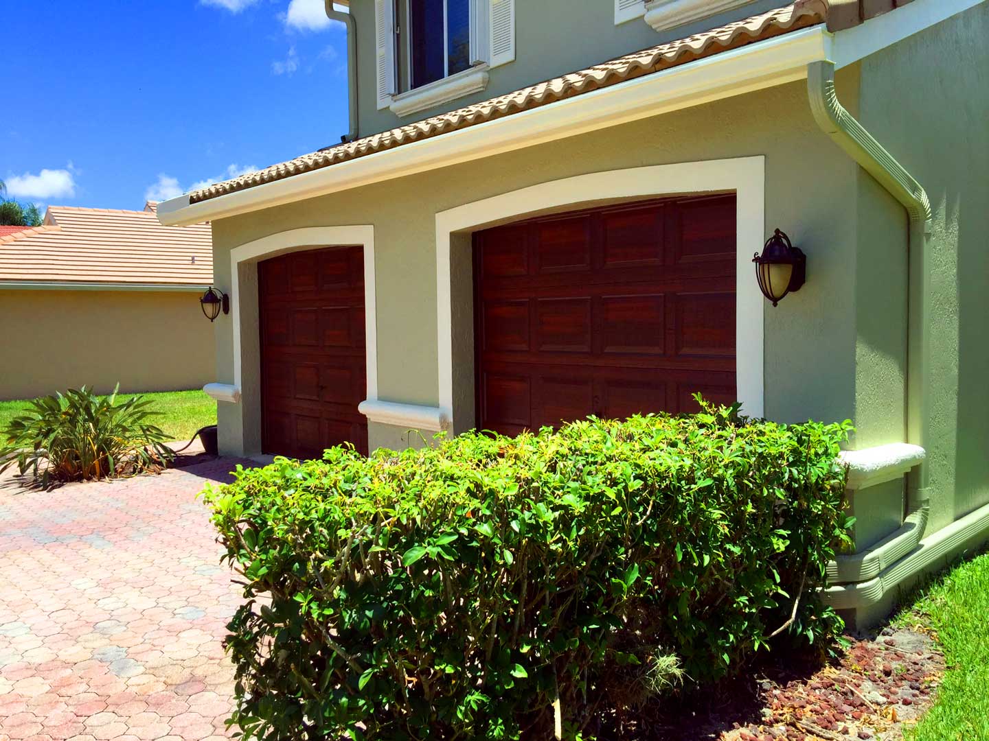 Faux mahogany finish on two single garage doors